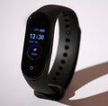 Smart fitness tracker watch showing heart rate on wrist